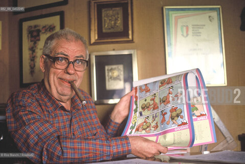 Rome May 4, 1993..Benito Franco Giuseppe Jacovitti, cartoonist, author of famous comic book characters such as Cocco Bill and Cip the Archpoliceman, graphic novels such as Kamasultra and the famous Diario Vitt, published since 1949 and which between the 1960s and 1970s sold over 3 million copies a year, exceeding a total of 100 million copies, photographed in his home in Rome/Benito Franco Giuseppe Jacovitti, fumettista, autore di celebri personaggi dei fumetti come Cocco Bill e Cip larcipoliziotto, di romanzi grafici come Kamasultra e del celebre Diario Vitt, edito dal 1949 e che fra gli anni sessanta e settanta arrivò a vendere oltre 3 milioni di copie lanno superando un totale di 100 milioni di copie, fotografato a Roma nella sua abitazione. ©Rino Bianchi/Rosebud2