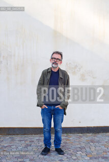 Biella, September 11, 2026..Guido Catalano, an Italian poet and writer who writes for *Il Corriere della Sera Torino* and *Torino Sette* (part of *La Stampa*) and collaborates with *Smemoranda*, photographed in Biella in front of the former De Agostini factory during the Fuoriluogo Festival/Guido Catalano poeta e scrittore italiano, scrive per Il Corriere della Sera Torino, Torino Sette de La Stampa e collabora con Smemoranda, fotografato a Biella davanti lex Opificio De Agostini durante il Festival Fuoriluogo. ©Rino Bianchi/Rosebud2