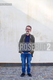 Biella, September 11, 2026..Guido Catalano, an Italian poet and writer who writes for *Il Corriere della Sera Torino* and *Torino Sette* (part of *La Stampa*) and collaborates with *Smemoranda*, photographed in Biella in front of the former De Agostini factory during the Fuoriluogo Festival/Guido Catalano poeta e scrittore italiano, scrive per Il Corriere della Sera Torino, Torino Sette de La Stampa e collabora con Smemoranda, fotografato a Biella davanti lex Opificio De Agostini durante il Festival Fuoriluogo. ©Rino Bianchi/Rosebud2