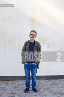 Biella, September 11, 2026..Guido Catalano, an Italian poet and writer who writes for *Il Corriere della Sera Torino* and *Torino Sette* (part of *La Stampa*) and collaborates with *Smemoranda*, photographed in Biella in front of the former De Agostini factory during the Fuoriluogo Festival/Guido Catalano poeta e scrittore italiano, scrive per Il Corriere della Sera Torino, Torino Sette de La Stampa e collabora con Smemoranda, fotografato a Biella davanti lex Opificio De Agostini durante il Festival Fuoriluogo. ©Rino Bianchi/Rosebud2