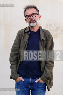 Biella, September 11, 2026..Guido Catalano, an Italian poet and writer who writes for *Il Corriere della Sera Torino* and *Torino Sette* (part of *La Stampa*) and collaborates with *Smemoranda*, photographed in Biella in front of the former De Agostini factory during the Fuoriluogo Festival/Guido Catalano poeta e scrittore italiano, scrive per Il Corriere della Sera Torino, Torino Sette de La Stampa e collabora con Smemoranda, fotografato a Biella davanti lex Opificio De Agostini durante il Festival Fuoriluogo. ©Rino Bianchi/Rosebud2