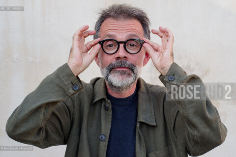 Biella, September 11, 2026..Guido Catalano, an Italian poet and writer who writes for *Il Corriere della Sera Torino* and *Torino Sette* (part of *La Stampa*) and collaborates with *Smemoranda*, photographed in Biella in front of the former De Agostini factory during the Fuoriluogo Festival/Guido Catalano poeta e scrittore italiano, scrive per Il Corriere della Sera Torino, Torino Sette de La Stampa e collabora con Smemoranda, fotografato a Biella davanti lex Opificio De Agostini durante il Festival Fuoriluogo. ©Rino Bianchi/Rosebud2