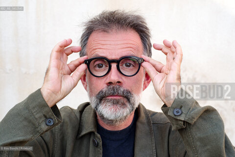 Biella, September 11, 2026..Guido Catalano, an Italian poet and writer who writes for *Il Corriere della Sera Torino* and *Torino Sette* (part of *La Stampa*) and collaborates with *Smemoranda*, photographed in Biella in front of the former De Agostini factory during the Fuoriluogo Festival/Guido Catalano poeta e scrittore italiano, scrive per Il Corriere della Sera Torino, Torino Sette de La Stampa e collabora con Smemoranda, fotografato a Biella davanti lex Opificio De Agostini durante il Festival Fuoriluogo. ©Rino Bianchi/Rosebud2