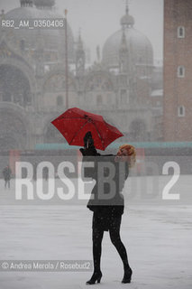 Una signora si diverte a giocare con lombrello sotto la neve che oggi pomeriggio, 17 dicembre 2010, ha imbiancato piazza San Marco. ©Andrea Merola/Rosebud2