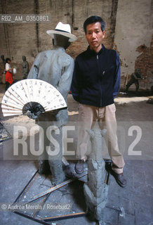 Cai Guo - Qiang, artista scultore, posa tra sue opere alla Biennale Arte di Venezia, 9 giugno 1999..Chinese sculptor Cai Guo-Qiang poses next his work at Biennale Modern Art Exhibition, june 09, 1999 Venice. ©Andrea Merola/Rosebud2