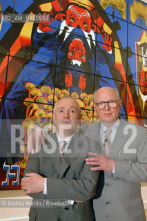 Gilbert & George (sx e dx, Gilbert Prousch e George Passmore), artisti polivalenti contemporanei, posano accanto una loro opera, nel padiglione britannico alla Biennale Ari Visive di Venezia, 8 giugno 2005..British artists Gilbert & George (L-Gilbert Prousch, R-George Passmore) pose next their work, in british pavillon at Biennale Modern Art Exhibition, june 08, Venice 2005. ©Andrea Merola/Rosebud2