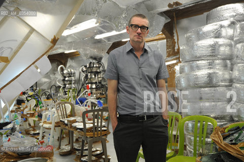 Thomas Hirschhorn, artista concettuale svizzero, posa tra sue opere esposte al padiglione Svizzera, durante la Biennale Arte di Venezia, Venezia, 31 maggio 2011. ©Andrea Merola/Rosebud2