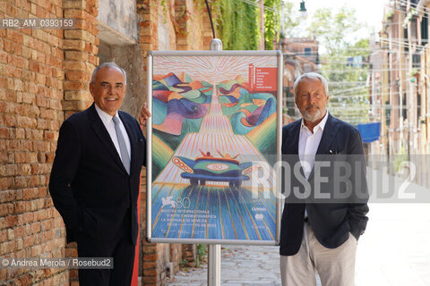 Da sx a dx: il direttore del settore Cinema della Biennale Alberto Barbera e il presidente della Biennale Roberto Cicutto posano accanto il manifesto di Venezia Cinema 80, oggi 25 luglio 2023, al termine della conferenza stampa di presentazione della Mostra Internazionale di Arte Cinematografica 2023, presso la biblioteca ASAC nel sestiere di Castello. ©Andrea Merola/Rosebud2