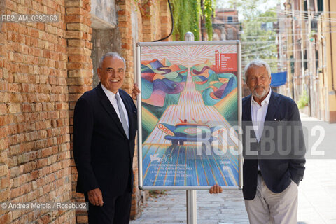 Da sx a dx: il direttore del settore Cinema della Biennale Alberto Barbera e il presidente della Biennale Roberto Cicutto posano accanto il manifesto di Venezia Cinema 80, oggi 25 luglio 2023, al termine della conferenza stampa di presentazione della Mostra Internazionale di Arte Cinematografica 2023, presso la biblioteca ASAC nel sestiere di Castello. ©Andrea Merola/Rosebud2