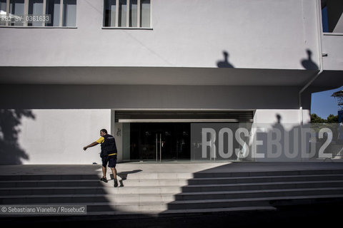 Lido di Venezia, 21 Agosto 2017. Lavori di allestimento del Palazzo del Cinema per la 74a edizione della Mostra Internazionale del Cinema di Venezia. Un operaio sale la gradinata laterale del Palazzo del Cinema. ©Sebastiano Vianello/Rosebud2