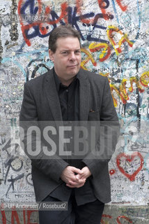 Douglas Kennedy in Berlin with part of the wall at Postdamer Platz. Berlin, September 8, 2011 - ©Ulf Andersen/Rosebud2